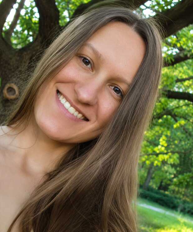 Olenka Sakhadzhan smiling outdoors