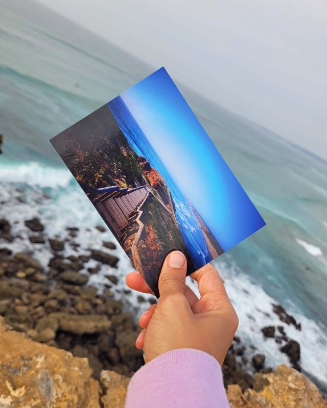 Olenka by the sea, holding a photograph